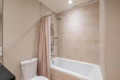 a bathroom with a white tub and a toilet at Fitzsimmons Walk 35 by Outpost Whistler in Whistler