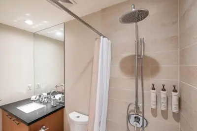 a bathroom with a shower with a toilet and a sink at Fitzsimmons Walk 35 by Outpost Whistler in Whistler