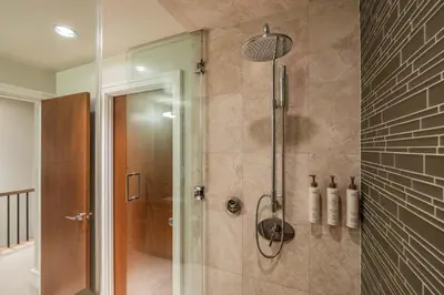 a shower with a glass door in a bathroom at Fitzsimmons Walk 35 by Outpost Whistler in Whistler