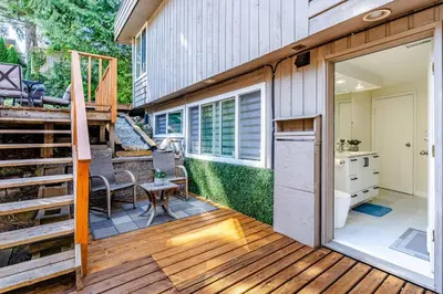 a sliding glass door on a deck with a kitchen at Spacious 3Bedrooms Family Getaway in North Vancouver in North Vancouver