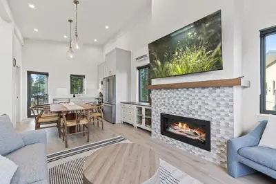 a living room with a fireplace and a dining room at Family-Friendly Beachside Bliss in Oyster Bay