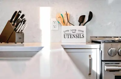 a kitchen with a counter with a box of utensils at Family-Friendly Beachside Bliss in Oyster Bay
