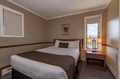 a bedroom with a large bed and a window at Radium Chalet in Radium Hot Springs