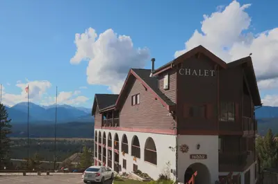 a building with a car parked in front of it at Radium Chalet in Radium Hot Springs