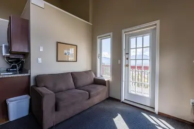 a living room with a couch and a window at Radium Chalet in Radium Hot Springs
