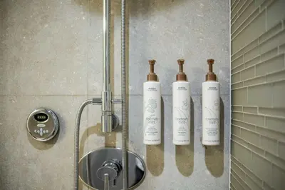 three bottles on a wall in a shower at Fitzsimmons Walk 37 by Outpost Whistler in Whistler