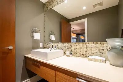 a bathroom with a sink and a mirror at Fitzsimmons Walk 37 by Outpost Whistler in Whistler