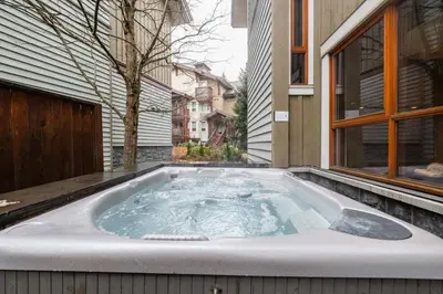 a hot tub in the backyard of a house at Fitzsimmons Walk 37 by Outpost Whistler in Whistler