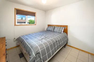 a bedroom with a bed and a window at Centrally located 1 Bed 1 Bath Ensuite Cute Guest Suite Private Laundry Pet OK in Calgary
