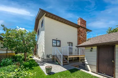 a house with a porch and a deck at Centrally located 1 Bed 1 Bath Ensuite Cute Guest Suite Private Laundry Pet OK in Calgary