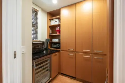 a kitchen with wooden cabinets and a stove at Fitzsimmons Walk 38 by Outpost Whistler in Whistler