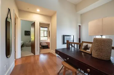 a living room with a table and a mirror at Fitzsimmons Walk 38 by Outpost Whistler in Whistler