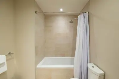 a bathroom with a bath tub and a toilet at Fitzsimmons Walk 38 by Outpost Whistler in Whistler