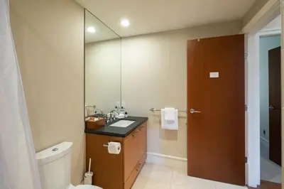 a bathroom with a sink and a toilet and a mirror at Fitzsimmons Walk 38 by Outpost Whistler in Whistler