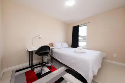 a bedroom with a bed and a desk and a window at 3BR 2BA Surrey Home | Quiet & Convenient in Surrey
