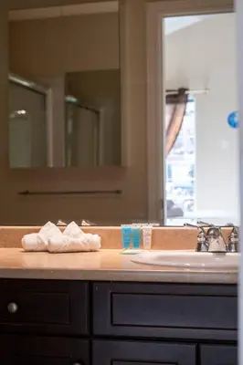 a bathroom counter with two towels and a sink at 3BR 2BA Surrey Home | Quiet & Convenient in Surrey