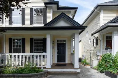 a house with a black door and a porch at 3BR 2BA Surrey Home | Quiet & Convenient in Surrey