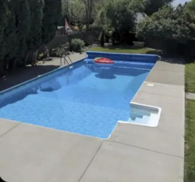 a blue swimming pool with a frisbee in it at Private SweetSuite 1 Bdrm Bathroom mini-kitchen in Kamloops