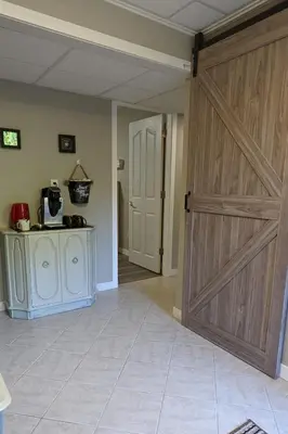 a large wooden door in a room with a kitchen at Private SweetSuite 1 Bdrm Bathroom mini-kitchen in Kamloops