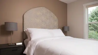 a bedroom with a white bed and a window at Klippers Guest Suites in Cawston