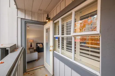 a room with windows and a hallway with a couch at Glacier Lodge 216 by Outpost Whistler in Whistler