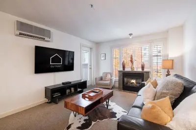 a living room with a couch and a fireplace at Glacier Lodge 216 by Outpost Whistler in Whistler