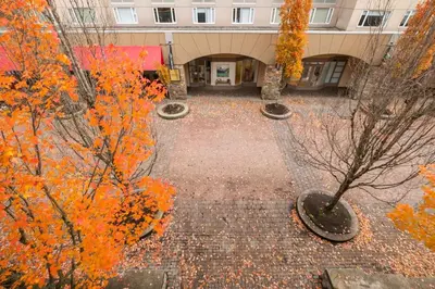 an empty courtyard with orange trees in front of a building at Glacier Lodge 309 by Outpost Whistler in Whistler