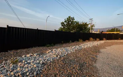 a fence with rocks on the side of a road at Coast Penticton Hotel in Penticton