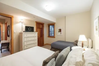 a bedroom with two beds and a dresser at Heron Chalet by Outpost Whistler in Whistler