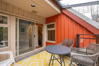 a screened in porch with a table and chairs at Lake Placid Lodge 18 by Outpost Whistler in Whistler