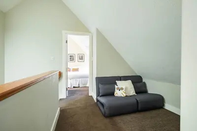 a room with a chair with a dog pillow on it at Lake Placid Lodge 18 by Outpost Whistler in Whistler