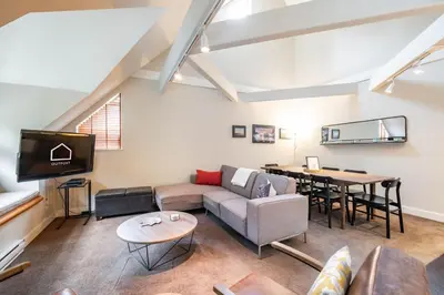 a living room with a couch and a table at Lake Placid Lodge 18 by Outpost Whistler in Whistler