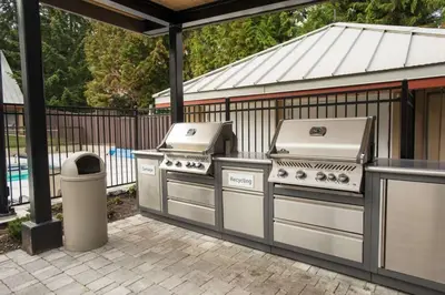 two bbqurgers are sitting on a patio at Lake Placid Lodge 18 by Outpost Whistler in Whistler