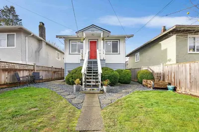 a house with a staircase leading to a red door at Private Entire Guest Suite, 1 min to bus stops to Downtown and major attractions in Vancouver