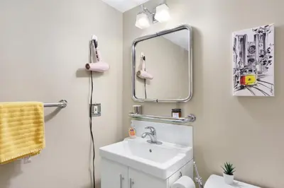 a bathroom with a sink and a mirror at Cozy Home in Downtown Minutes from Seawall in Vancouver