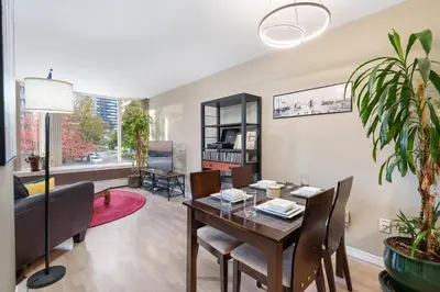a dining room and living room with a table and chairs at Cozy Home in Downtown Minutes from Seawall in Vancouver