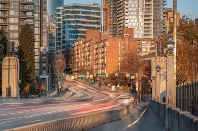 a busy city street with buildings and cars at Cozy Home in Downtown Minutes from Seawall in Vancouver