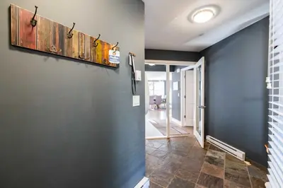 a hallway with blue walls and a tile floor at Lynx 204 by Outpost Whistler in Whistler