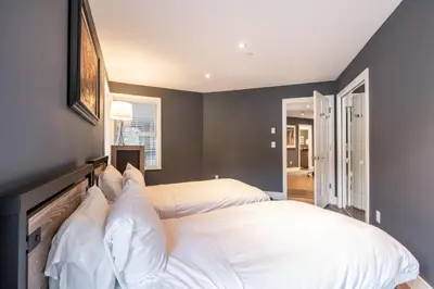 a bedroom with two beds with white pillows at Lynx 204 by Outpost Whistler in Whistler
