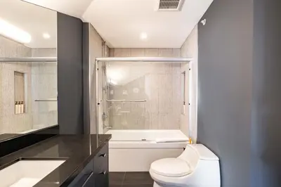 a bathroom with a white toilet and a shower at Lynx 204 by Outpost Whistler in Whistler