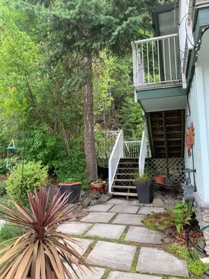 a stairway leading up to a house with a patio at West facing Waterfront Retreat with private beach, dock access & private buoy in Blind Bay