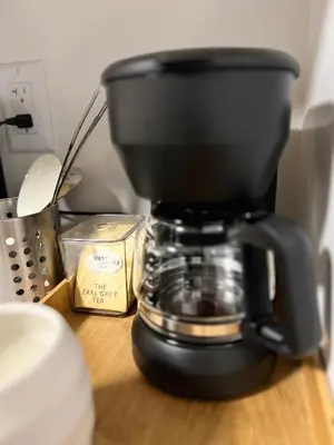 a black coffee maker sitting on a wooden table at 1Bd Modern Suite close to Langley Events Centre and Hwy1 in Langley