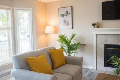 a living room with a couch and a fireplace at Cozy Calgary Hideaway in Calgary