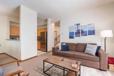 a living room with a couch and a table at Northstar 51 by Outpost Whistler in Whistler