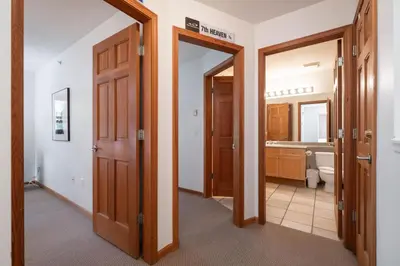 a hallway with two doors and a bathroom at Northstar 51 by Outpost Whistler in Whistler
