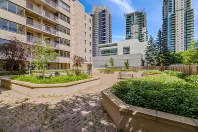 a park in the middle of a city with tall buildings at Modern 2 bedroom next to Stampede, 17th w Parking in Calgary