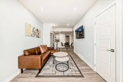 a living room with a couch and a table at 2 Beds, 1 bath Walkout Basement in Calgary