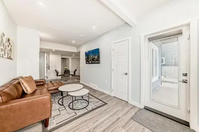 a living room with a couch and a table at 2 Beds, 1 bath Walkout Basement in Calgary