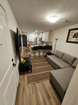 a living room with a couch and a table at Emeka & Comfort in Calgary