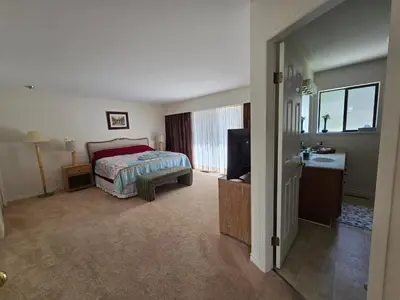 a bedroom with a bed and a television in it at Luxury 3BR Home, 2 King Beds, Near cafes and groceries in North Vancouver
